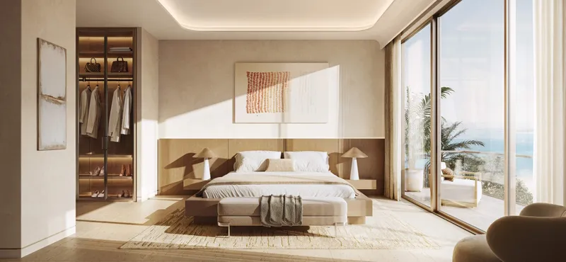 Master bedroom at SOMA Residences with an open walk-in wardrobe and a terrace beyond the glazing