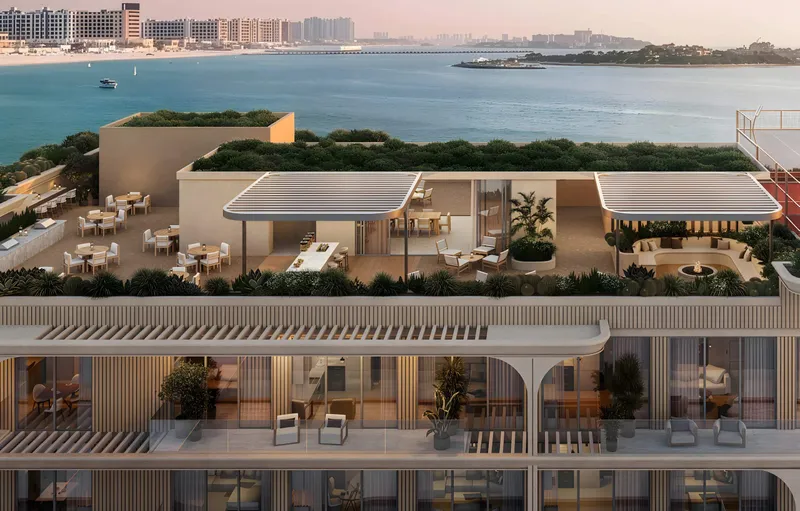 Rooftop terrace at SOMA Residences with shaded seating and a view across the water toward the mainland