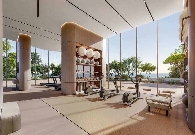 Gym with floor-to-ceiling glazing and sea views at Soulever