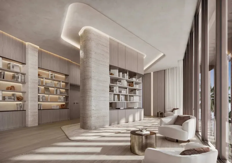 Residents’ library with built-in shelving and armchairs at Soulever