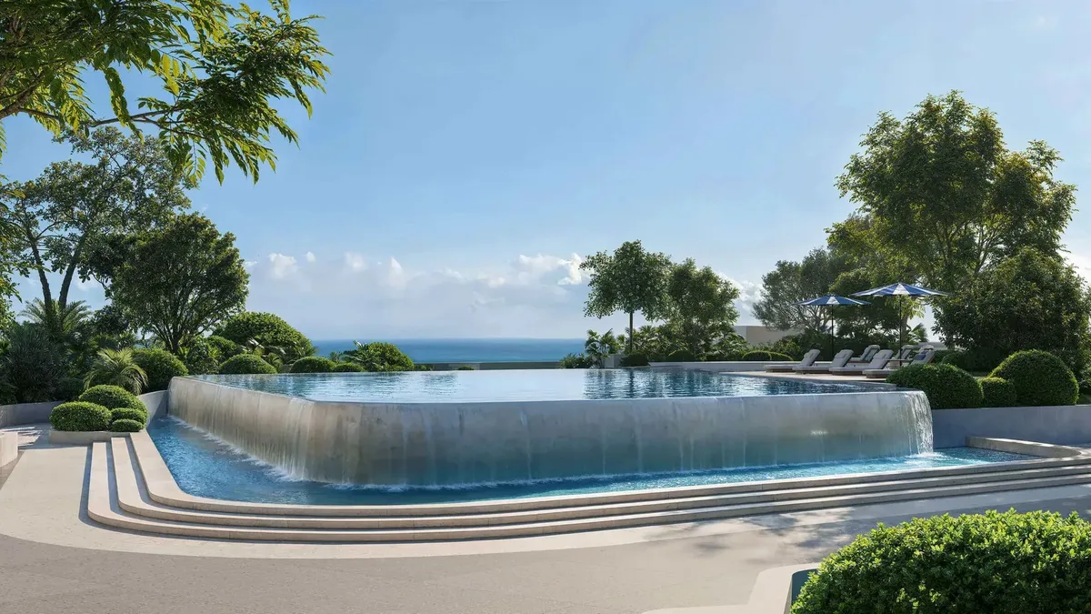 Infinity pool on the podium at Soulever with the sea beyond