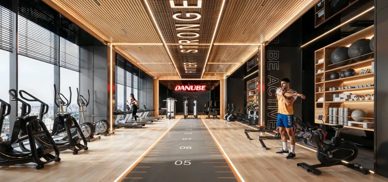 Indoor gym at Sparklz by Danube with cardio machines and full-height windows