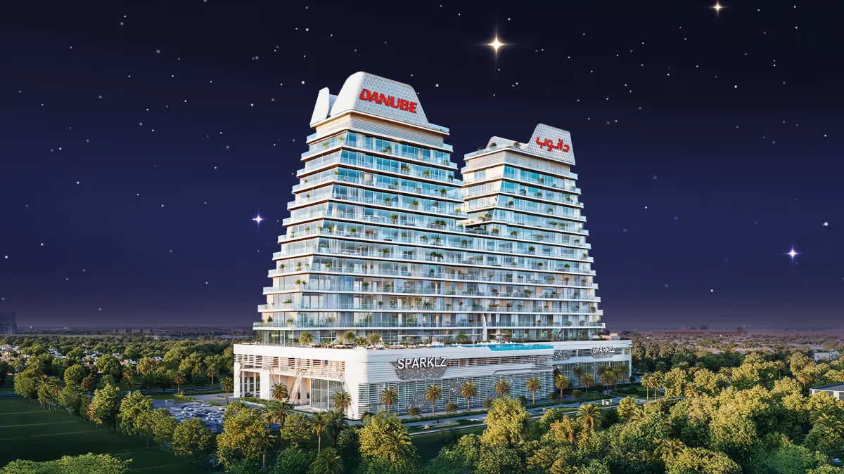 Sparklz by Danube, twin stepped towers at night in Al Furjan, Dubai