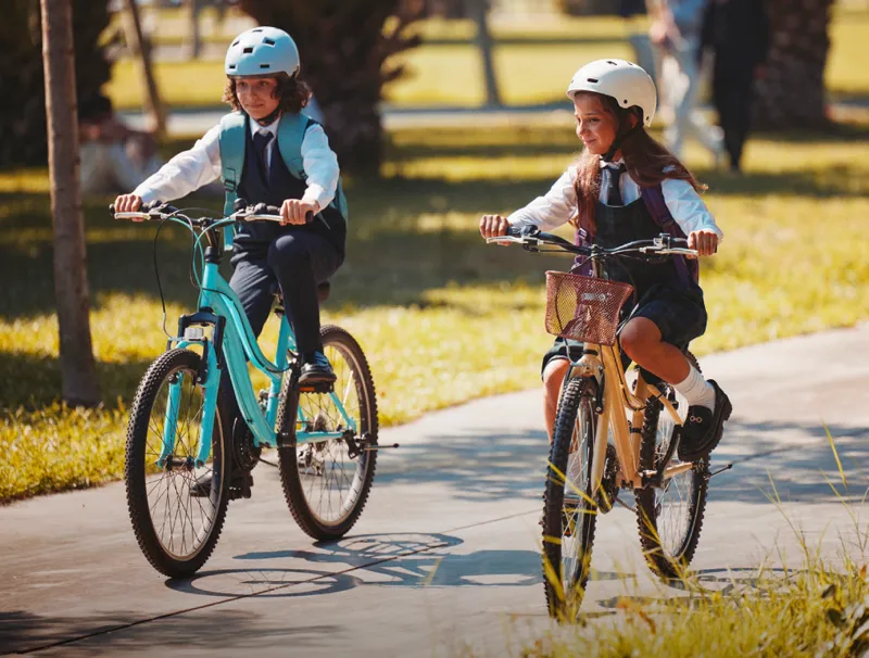 Children cycling on a shaded path at Talay, Marsa Al Saadiyat