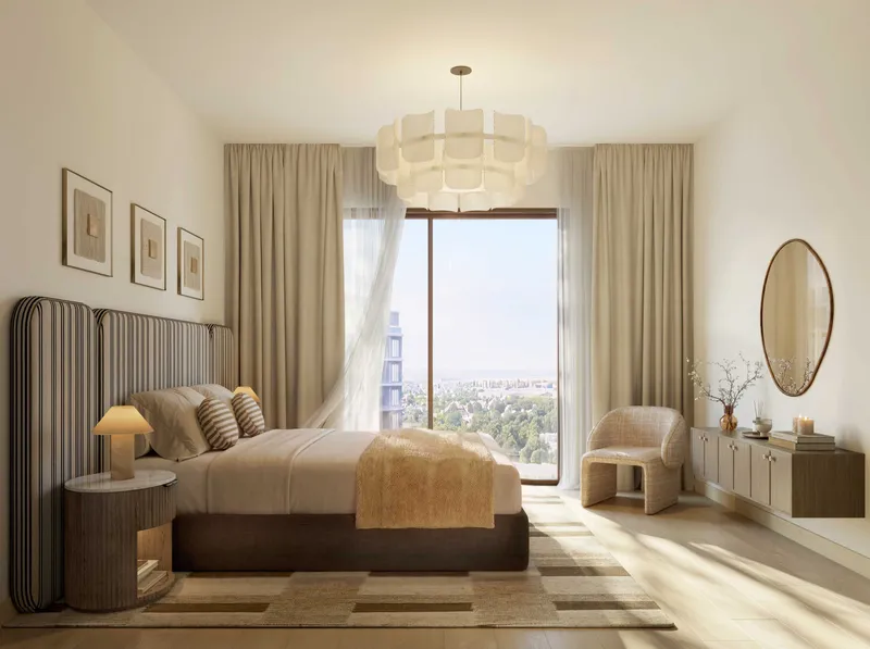 Apartment bedroom at The Canopies with a full-height window and soft neutral furnishings