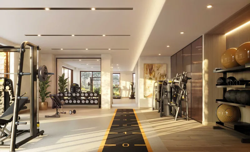Residents' gym at The Canopies with free weights, machines and a sprint track