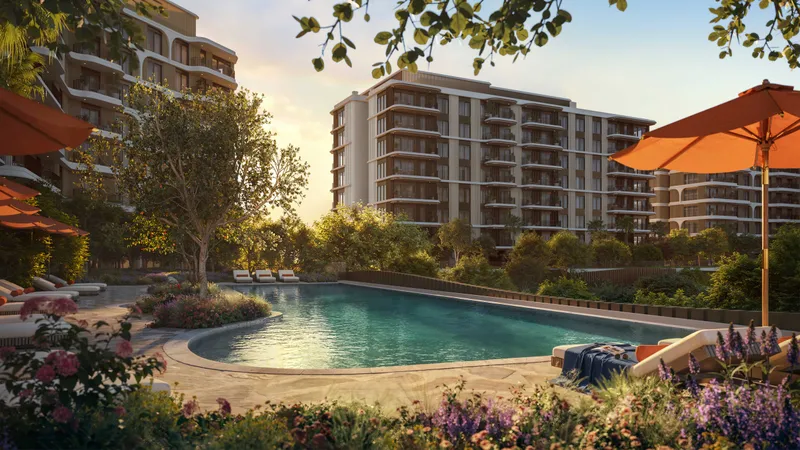 Resort-style pool at The Canopies at Yas Point with umbrellas and flowering planting