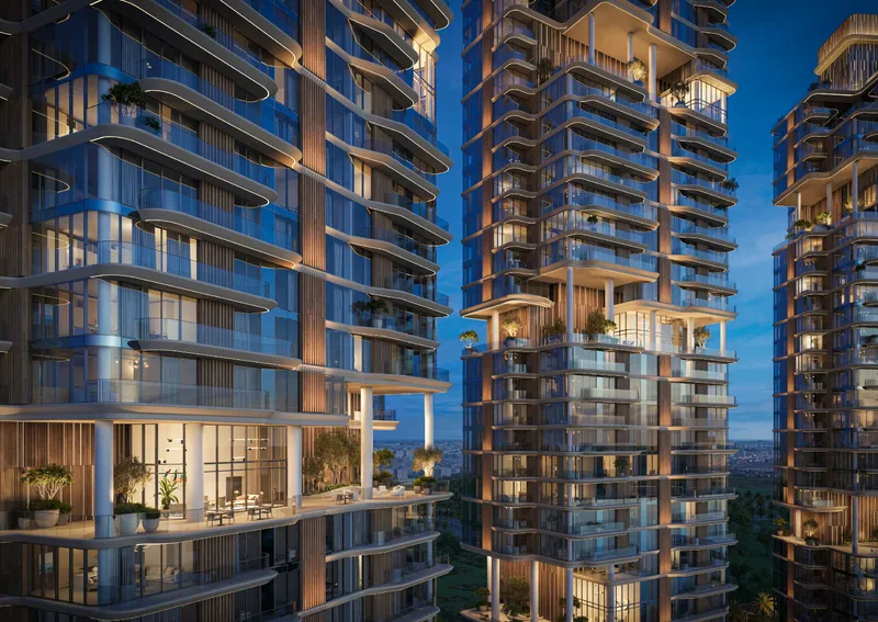 Evening render of The Edit at d3 showing curved balcony lines and a recessed sky garden in the facade