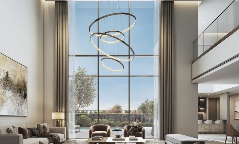 Living room with full-height windows onto the garden in a villa at The Orchard