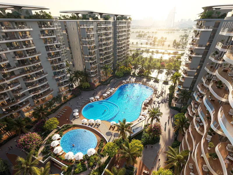 Pool courtyard with loungers and parasols between the Valencia apartment buildings