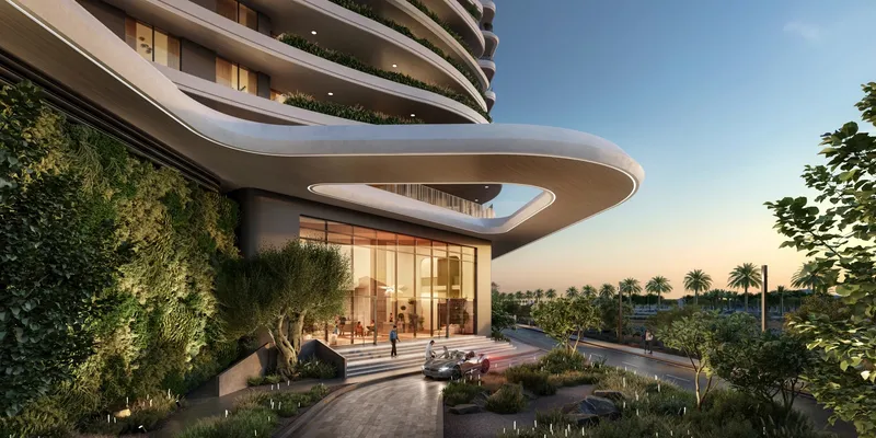 Render of a Verdes by Haven lobby entrance under a curved canopy with a green wall
