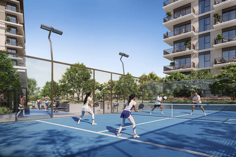Render of residents playing padel on a floodlit court between the Vista Ridge buildings