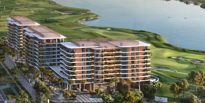 Aerial render of Waldorf Astoria Residences Yas buildings with curved terraces beside the Yas Links golf course and the water