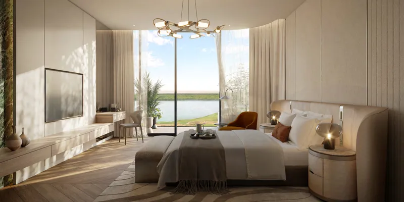 Render of a bedroom at Waldorf Astoria Residences Yas with an upholstered bed and a full-height window onto the water