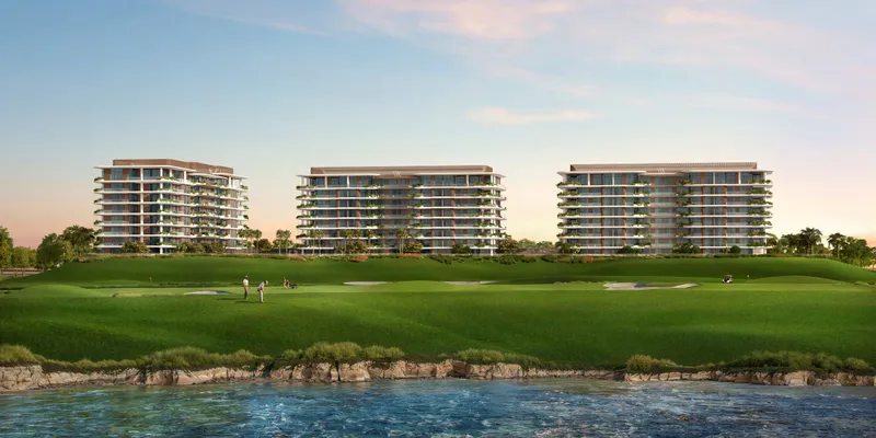 Render of the three mid-rise Waldorf Astoria Residences Yas buildings seen across the water and the Yas Links fairways