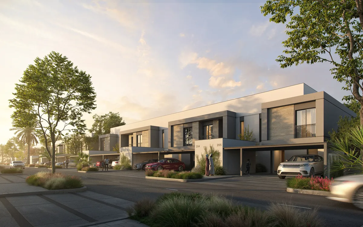 Render of a row of two-storey townhouses at The Orchids, Yas Acres, with covered parking and landscaped verges at sunset