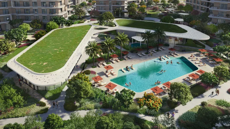 Aerial render of the Yas Park Place community pavilion with a green roof beside a family pool and landscaped gardens