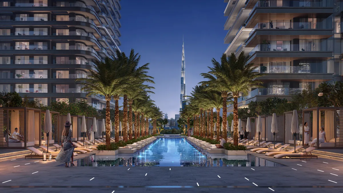 Render of a palm-lined pool between the Address Residences Zabeel towers at dusk, with Burj Khalifa in the distance