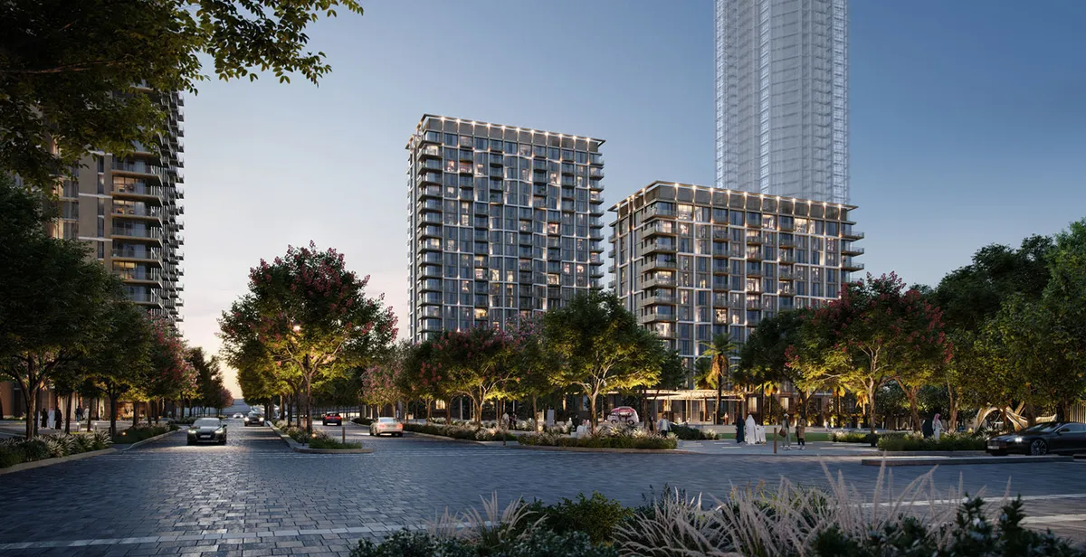 Render of the Aeon apartment buildings at dusk seen from the tree-lined street
