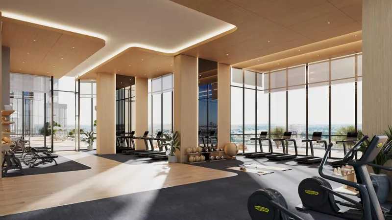 Gym with cardio machines and full-height windows at Al Habtoor Tower