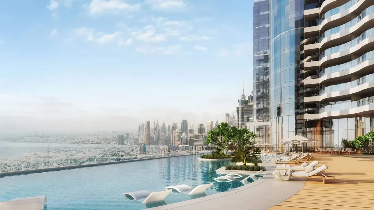 Infinity pool on an amenity deck of Al Habtoor Tower looking over the Dubai skyline and the sea