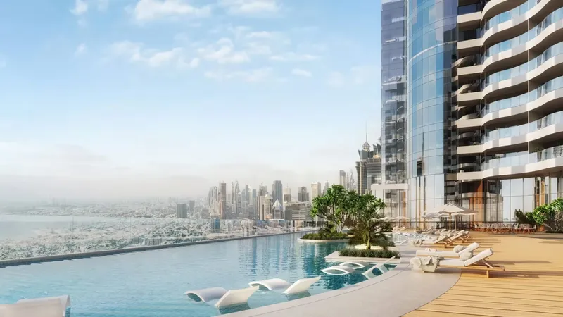 Infinity pool on an amenity deck of Al Habtoor Tower looking over the Dubai skyline and the sea