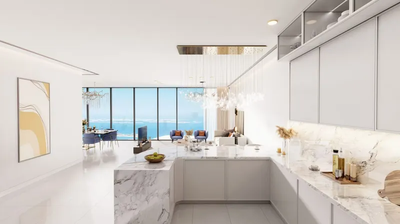 White kitchen with a marble island and sea views in an Al Habtoor Tower apartment