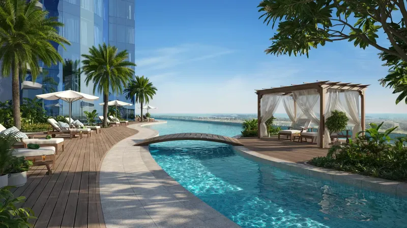 Curved pool with cabanas, loungers and palm trees on a leisure deck at Al Habtoor Tower