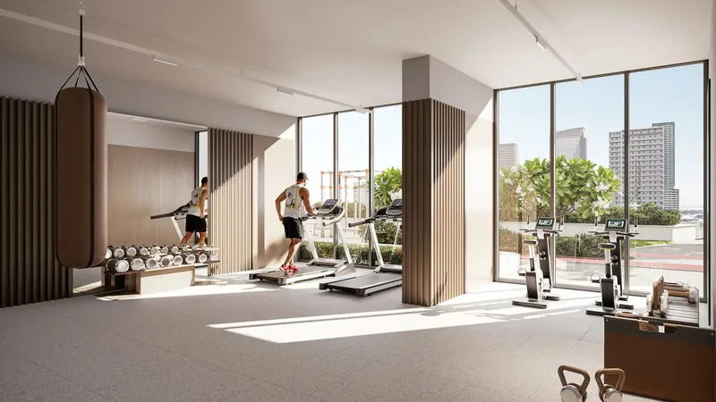Gym overlooking the podium at ALTA V1EW Skyhomes