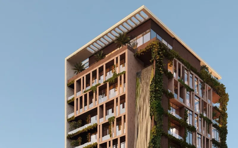 Upper floors of the Amazonia building with planted balconies, a green wall and a rooftop pergola