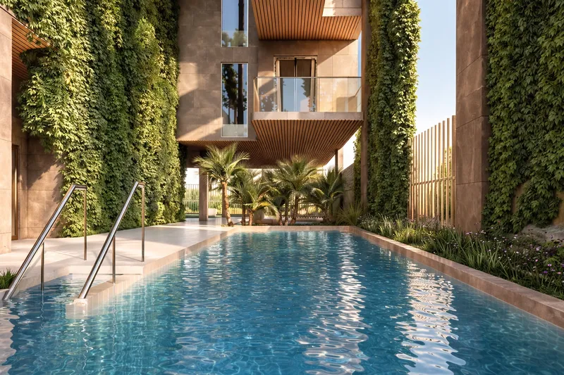 Swimming pool at Amazonia framed by green walls and palm trees