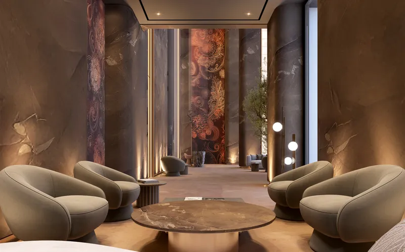 Interior render of the lobby lounge at Ananda Residences with armchairs and stone-clad columns