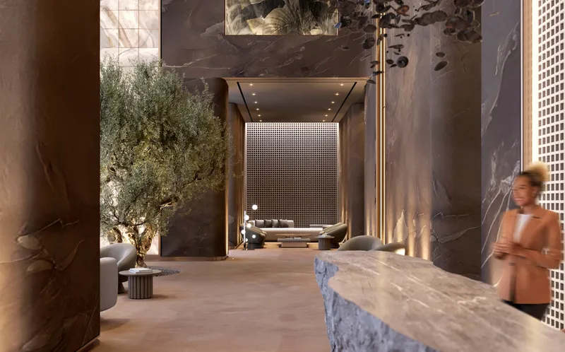 Interior render of the Ananda Residences lobby with a stone reception desk and an olive tree