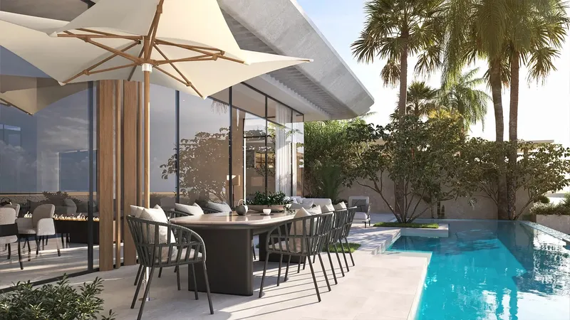 Outdoor dining terrace beside a private pool at an Anantara Residences villa