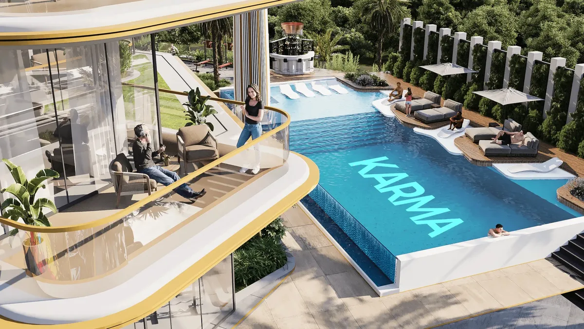 Podium swimming pool with sun loungers and cabanas seen from a curved balcony at Antalya by Karma