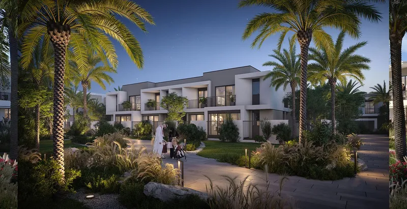 Render of Anya 2 townhouses at dusk along a landscaped footpath