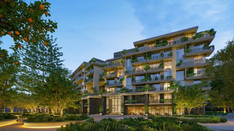 Dusk render of an Arancia Yards building with planted terraces, framed by orange trees