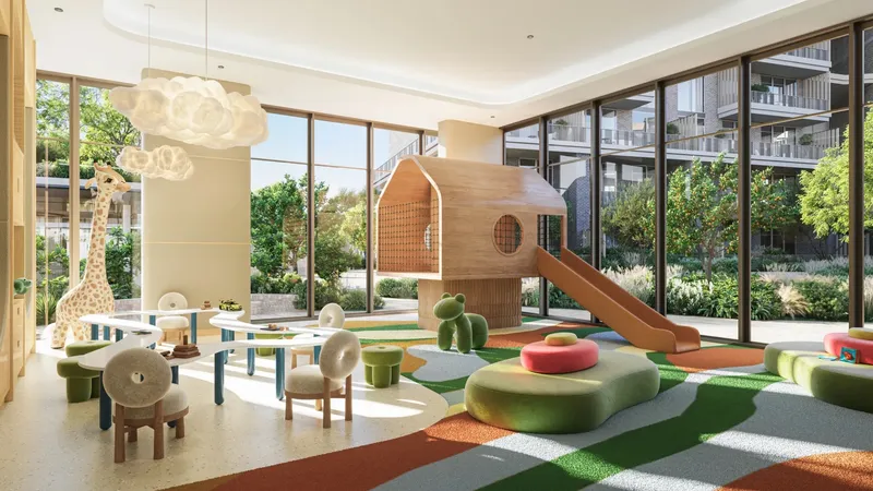 Indoor kids’ club with a timber play house, slide and garden views at Arancia Yards