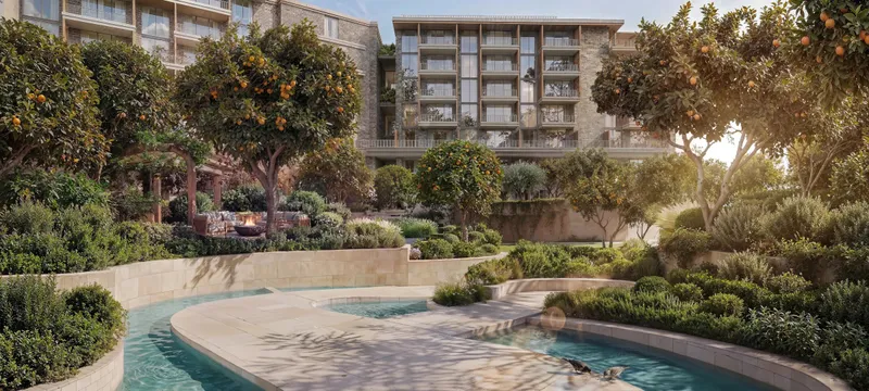 Cascading water feature among orange trees and planting in an Arancia Yards courtyard