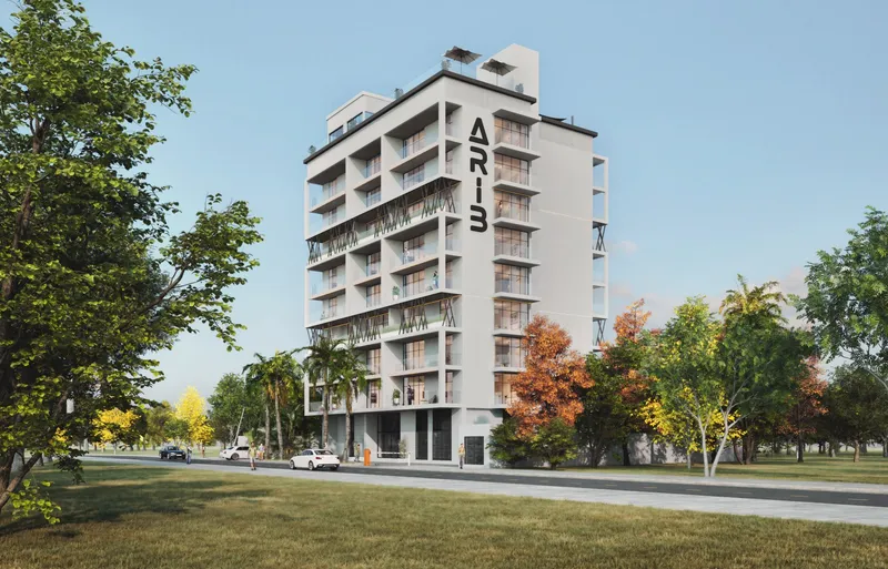 ARIB Collection building with balconies and street-level trees by day