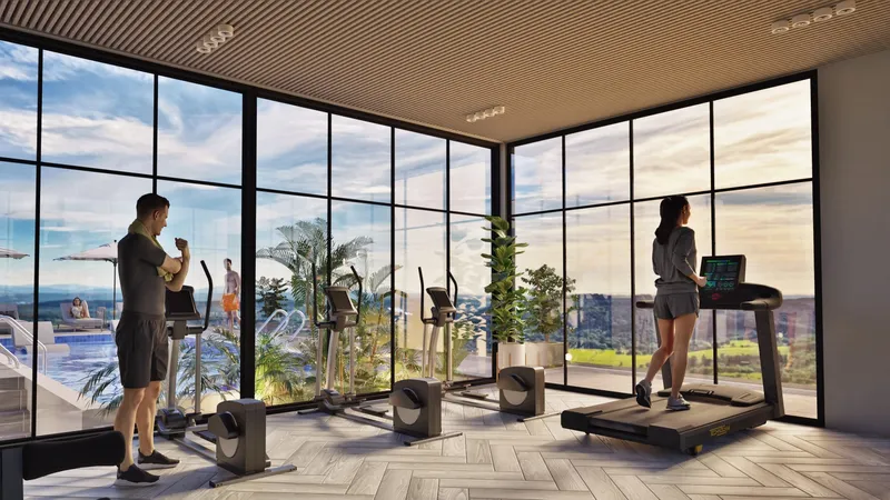 Glass-walled gym with treadmills and views at ARIB Collection