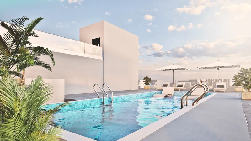 Rooftop pool deck with parasols and planting at ARIB Collection