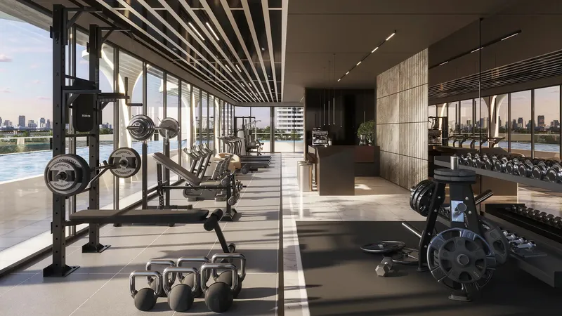 Fitness studio with weights and water views at ARYA Residences