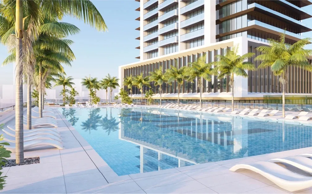 Render of the swimming pool at Auresta Tower with loungers and palm trees beside the building