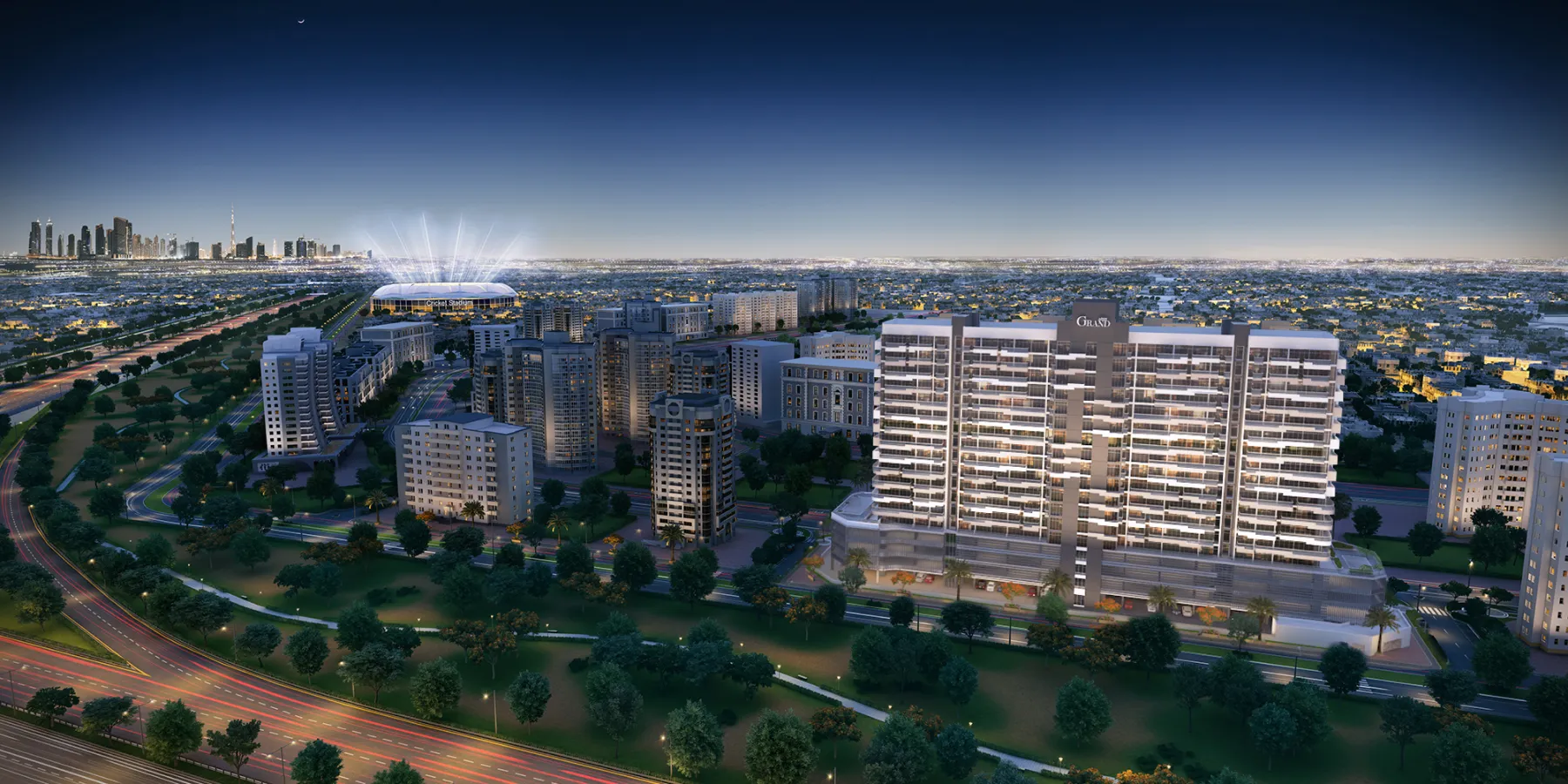 Aerial render of the Azizi Grand apartment building in Dubai Sports City at night