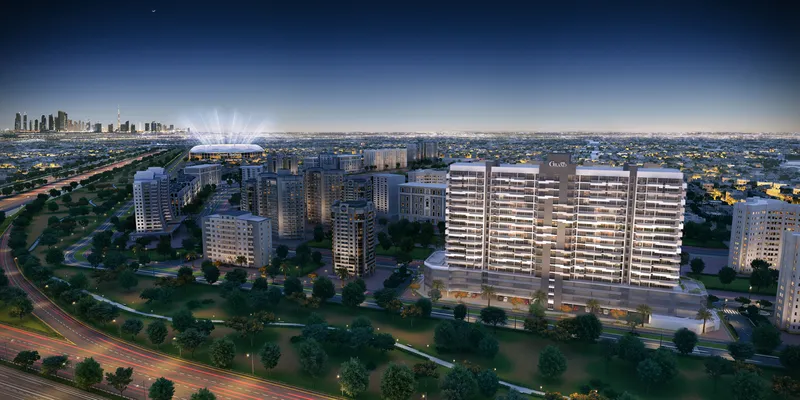 Aerial render of the Azizi Grand apartment building in Dubai Sports City at night