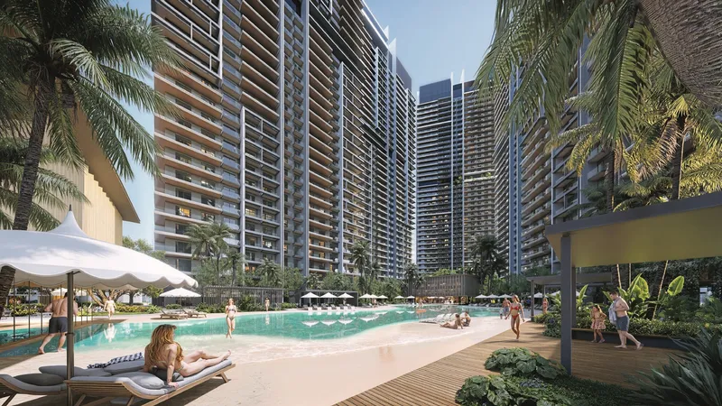 Render of the lagoon pool and sandy beach at Azizi Milan Heights, with the residential towers behind