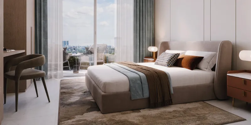 Render of a bedroom in an Azizi Noura apartment with a desk and full-height windows