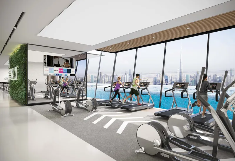 Residents' gymnasium with treadmills facing the lagoon at Azizi Riviera