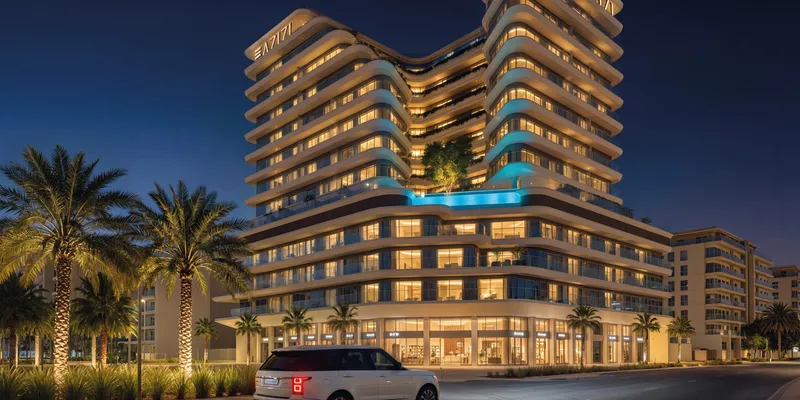 Render of Azizi Rose lit at night, with the pool deck above the podium